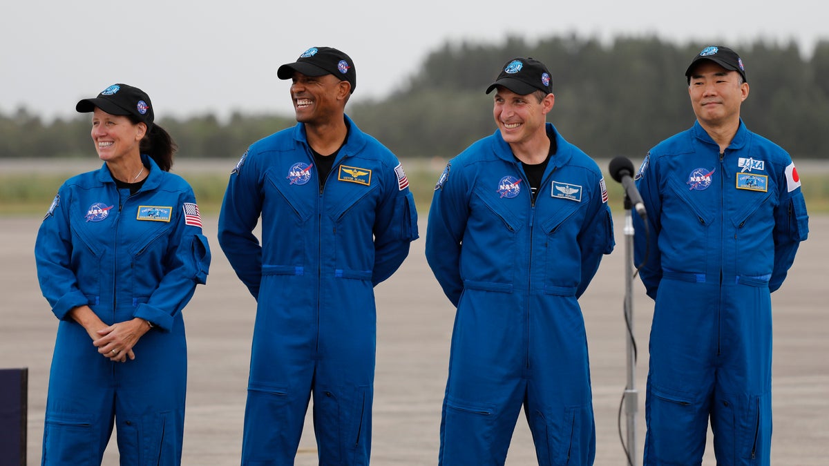 NASA Astronauts from left Shannon Walker, Victor Glover, Michael Hopkins and Japan Aerospace Exploration Agency Astronaut Soichi Noguchi smile during a news conference after they arrived at the Kennedy Space Center, Sunday, Nov. 8, 2020, in Cape Canaveral, Fla. The four astronauts will fly on the SpaceX Crew-1 mission to the International Space Station scheduled for launch on Nov. 14, 2020 (AP Photo/Terry Renna)
