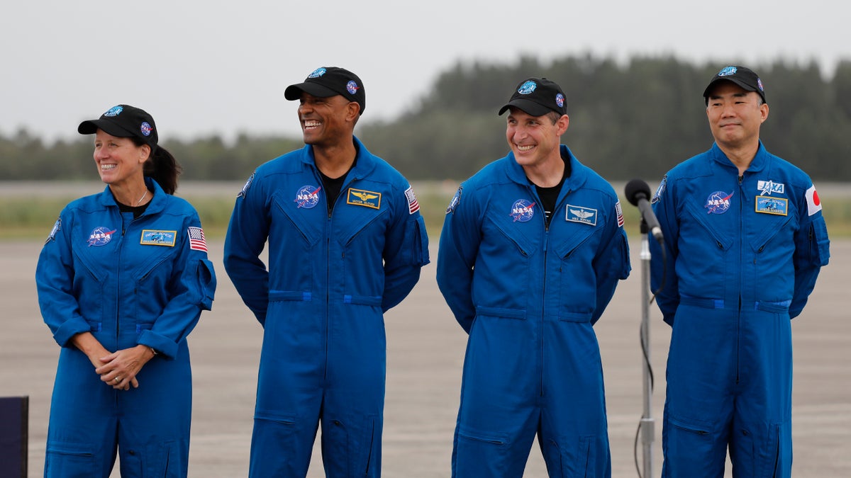 NASA Astronauts from left Shannon Walker, Victor Glover, Michael Hopkins and Japan Aerospace Exploration Agency Astronaut Soichi Noguchi smile during a news conference after they arrived at the Kennedy Space Center, Sunday, Nov. 8, 2020, in Cape Canaveral, Fla. The four astronauts will fly on the SpaceX Crew-1 mission to the International Space Station scheduled for launch on Nov. 14, 2020 (AP Photo/Terry Renna)