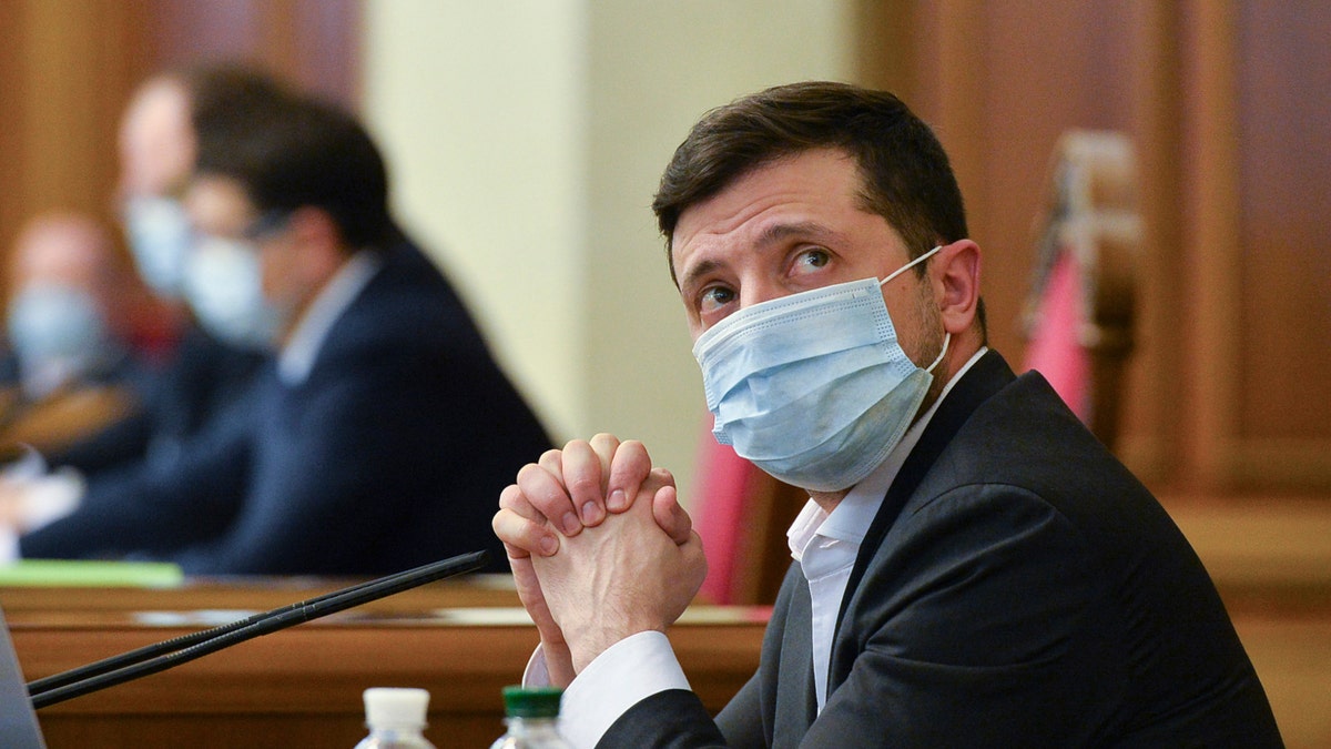 Ukrainian President Volodymyr Zelensky wears a face mask to protect against coronavirus during an extraordinary parliamentary session in Kyiv, Ukraine on March 31, 2020. (AP Photo, FILE)