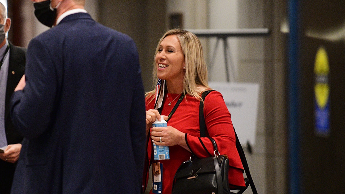 Rep.-elect Marjorie Taylor Greene, R-Ga., right, joins others for a chat during a congressional orientation on Capitol Hill in Washington, Friday, Nov. 13, 2020. (Astrid Riecken/The Washington Post via AP, Pool)