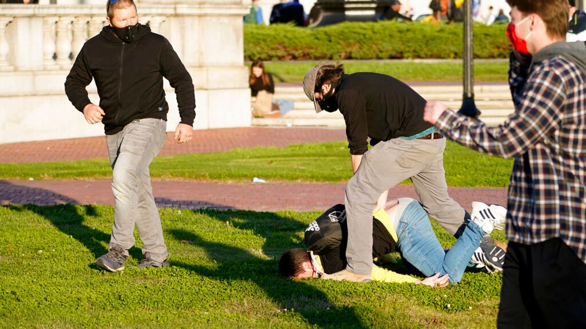 A supporter of President Donald Trump is attacked during a pro-Trump march Saturday Nov. 14, 2020, in Washington. (AP Photo/Jacquelyn Martin)