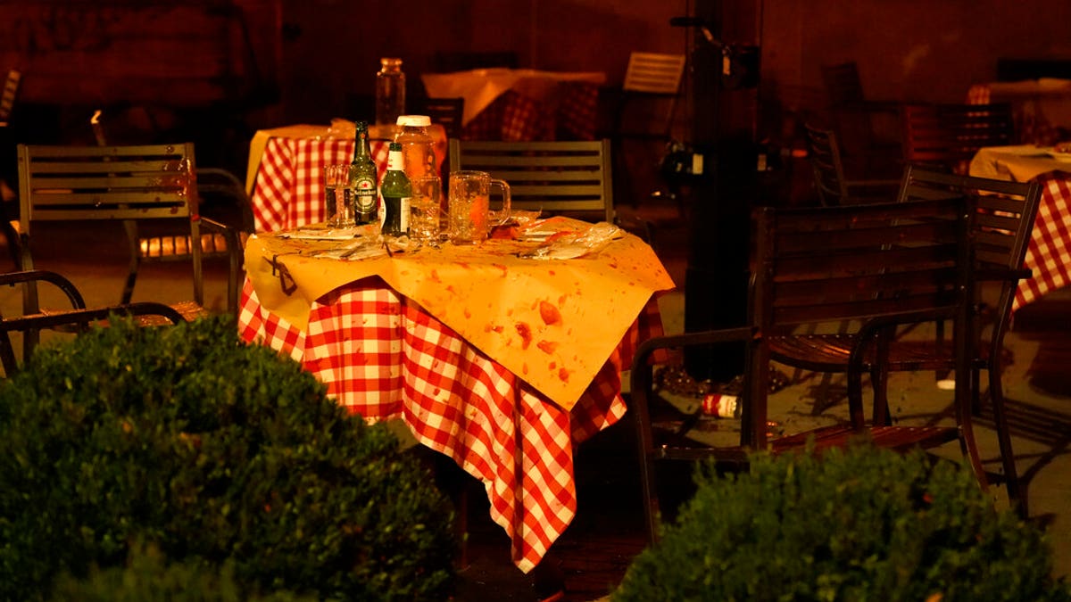 Soup is splattered on a table and chairs after a firework in a soup can was thrown into an area where supporters of President Donald Trump were eating and attending pro-Trump marches, Nov. 14, in Washington. (AP Photo/Jacquelyn Martin)