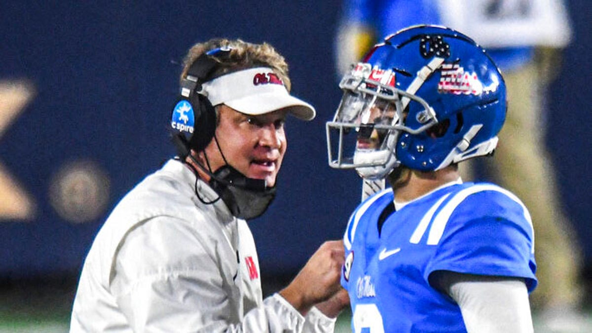 Mississippi coach Lane Kiffin talks with quarterback Matt Corral (2) durng the second half of the team's NCAA college football game against South Carolina in Oxford, Miss., Saturday, Nov. 14, 2020. 