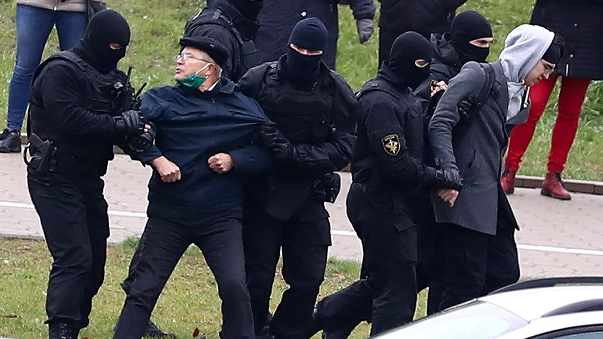 Belarusian riot police detain demonstrators during an opposition rally to protest the official presidential election results in Minsk, Belarus, Sunday, Nov. 15, 2020. (AP Photo)