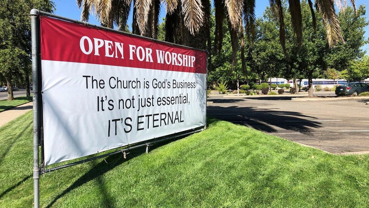 In this Thursday, July 9, 2020 file photo an "Open for Worship" banner is posted outside the Crossroads Community Church in Yuba City, Calif. (AP Photo/Adam Beam)