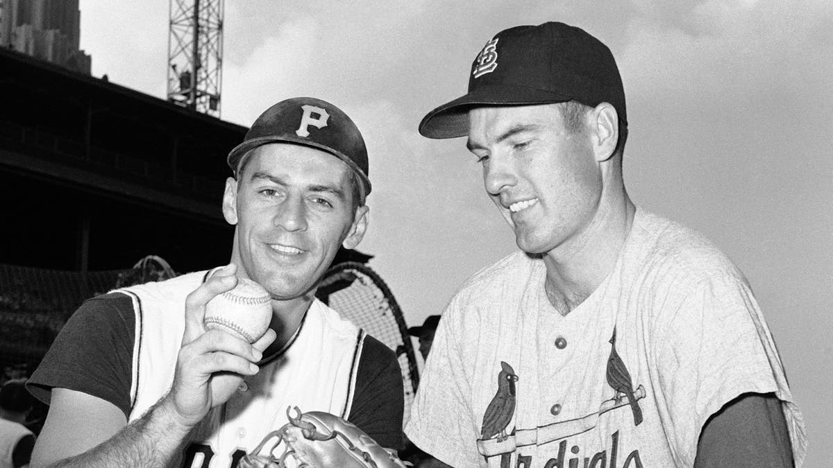 In this Aug. 11, 1960, file photo, shortstop Dick Groat, left, of the Pittsburgh Pirates, and pitcher Lindy McDaniel, of the St. Louis Cardinals, talk at Forbes Field in Pittsburgh. (AP Photo/File)