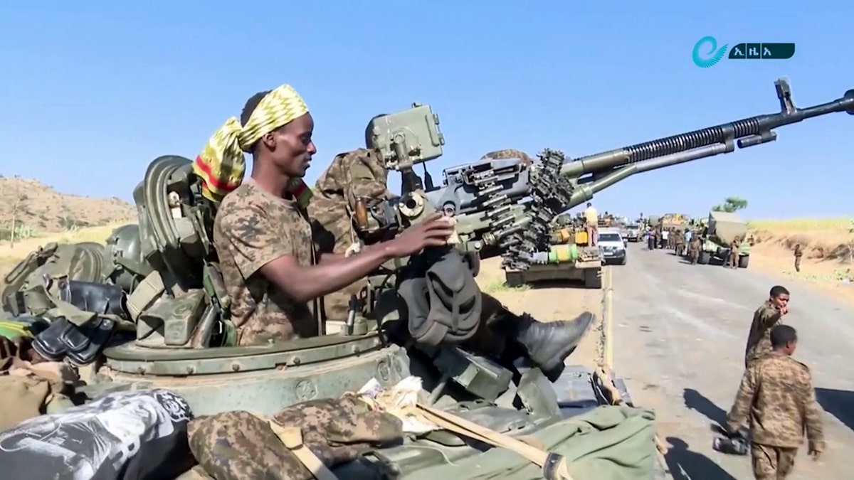 This image made from undated video released by the state-owned Ethiopian News Agency on Monday, Nov. 16, 2020 shows Ethiopian military in an armored personnel carrier, on a road in an area near the border of the Tigray and Amhara regions of Ethiopia. (Ethiopian News Agency via AP)