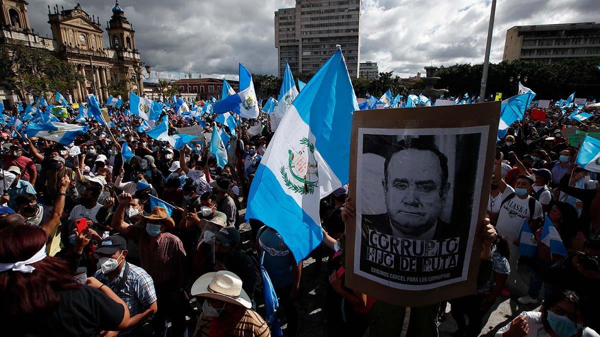 Protesters gather outside Congress in Guatemala City, Saturday, Nov. 21, 2020. Hundreds of protesters were protesting in various parts of the country Saturday against Guatemalan President Alejandro Giammattei and members of Congress for the approval of the 2021 budget that reduced funds for education, health and the fight for human rights. (AP Photo/Moises Castillo)