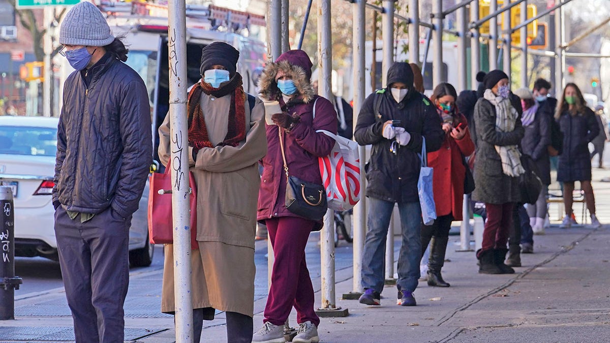 People wait on a line stretching around a block for a clinic offering COVID-19 testing, Wednesday, Nov. 18, 2020, in the Park Slope area of the Brooklyn borough of New York. (AP Photo/Bebeto Matthews)