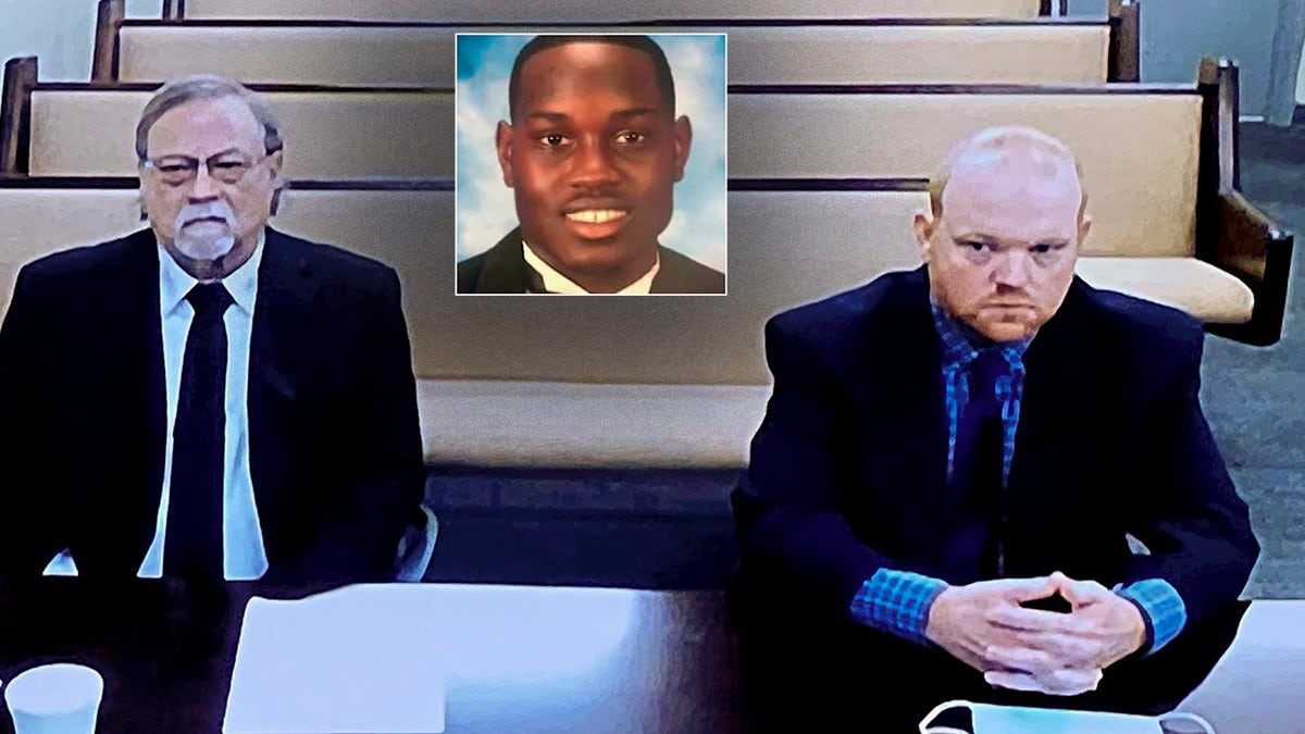 In this image made from video, Gregory McMichael (left) and his son Travis McMichael, accused in the shooting death of Ahmaud Arbery (inset) in Georgia in Feb. 2020, listen via closed-circuit TV in the Glynn County Detention center in Brunswick, Ga., on Thursday, Nov. 12, as lawyers argue for bond to be set at the Glynn County courthouse. (AP Photo/Lewis Levine)