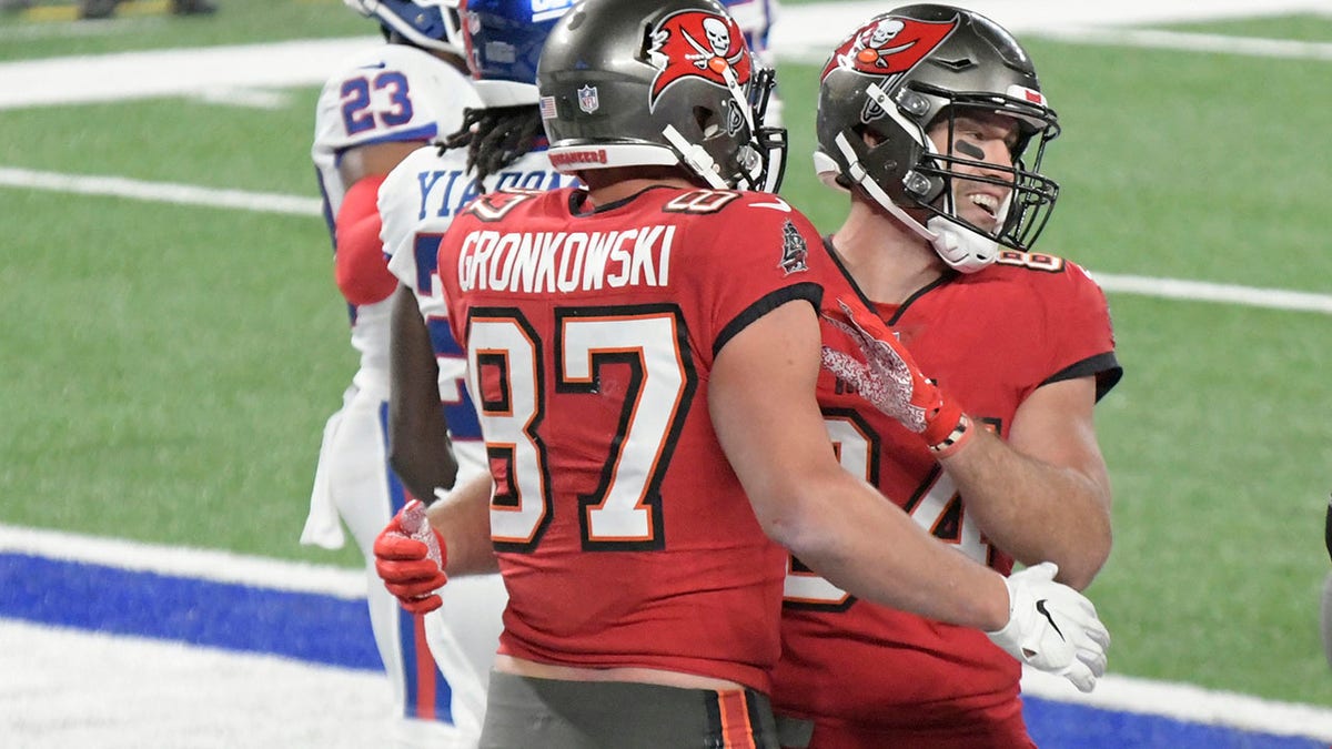 Tampa Bay Buccaneers' Rob Gronkowski (87), left, celebrates his touchdown with Cameron Brate during the second half of an NFL football game against the New York Giants, Monday, Nov. 2, 2020, in East Rutherford, N.J. (AP Photo/Bill Kostroun)