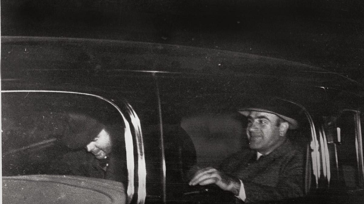 Al Capone, right, Chicago's infamous gang overlord during prohibition, leaves Harrisburg, Pa., on Nov. 16, 1939, with a federal officer for Lewisburg, Pa., where he was released after spending seven years in prison in Atlanta and San Francisco's Alcatraz. (AP Photo)