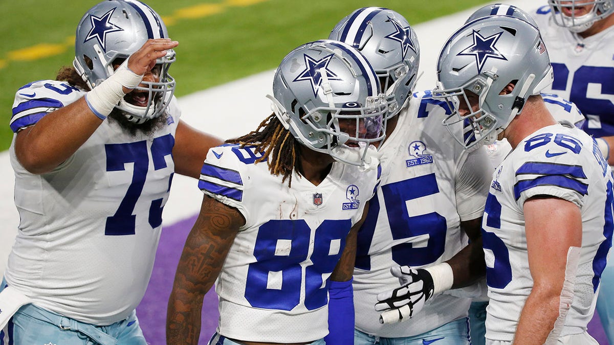 Dallas Cowboys wide receiver CeeDee Lamb (88) celebrates with teammates after catching a 4-yard touchdown pass during the first half of an NFL football game against the Minnesota Vikings, Sunday, Nov. 22, 2020, in Minneapolis. (AP Photo/Bruce Kluckhohn)