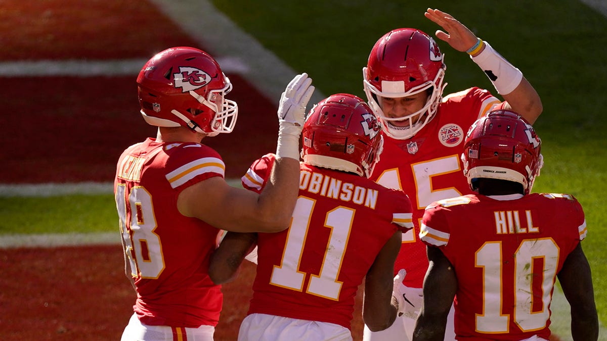 Kansas City Chiefs' Nick Keizer (48), Demarcus Robinson (11), Tyreek Hill (10) and Patrick Mahomes (15), celebrate a touchdown scored on a catch by Robinson in the second half of an NFL football game agains the New York Jets on Sunday, Nov. 1, 2020, in Kansas City, Mo. (AP Photo/Charlie Riedel)