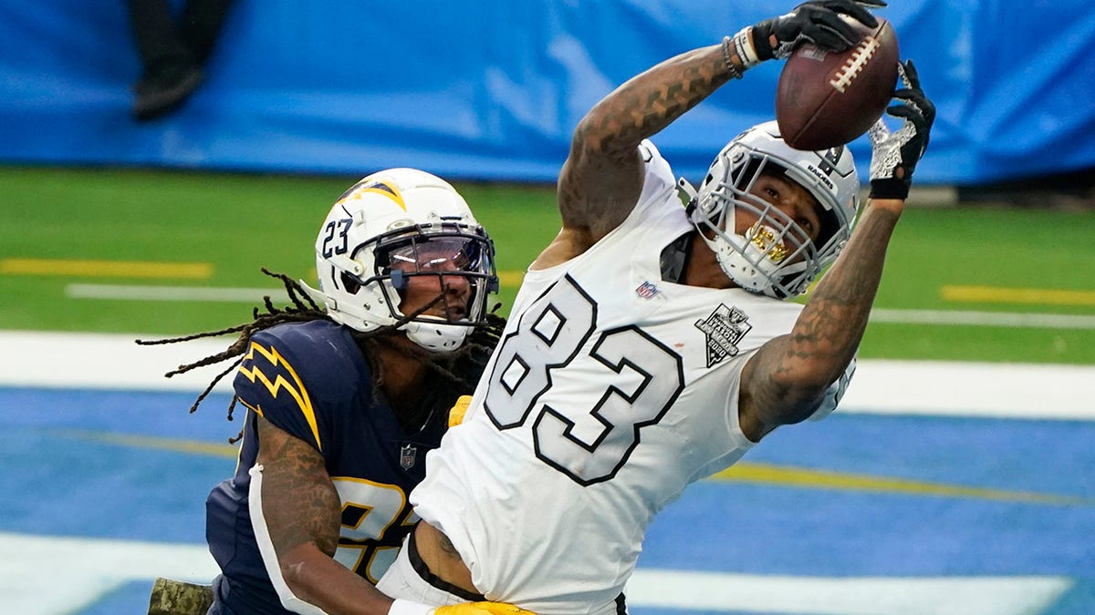 Las Vegas Raiders tight end Darren Waller (83) hauls in a touchdown pass as Los Angeles Chargers strong safety Rayshawn Jenkins defends second half of an NFL football game Sunday, Nov. 8, 2020, in Inglewood, Calif. (AP Photo/Alex Gallardo)