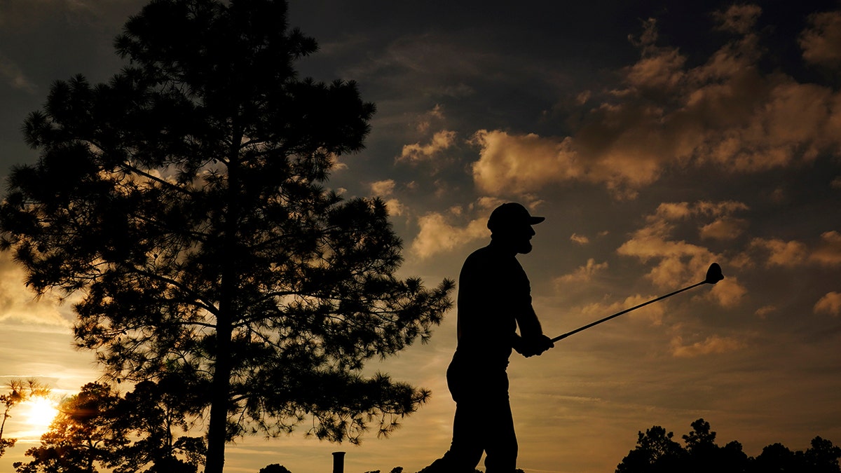 Dustin Johnson watches his shot on the 18th hole during the third round of the Masters golf tournament Nov. 14, in Augusta, Ga. (AP Photo/Matt Slocum)