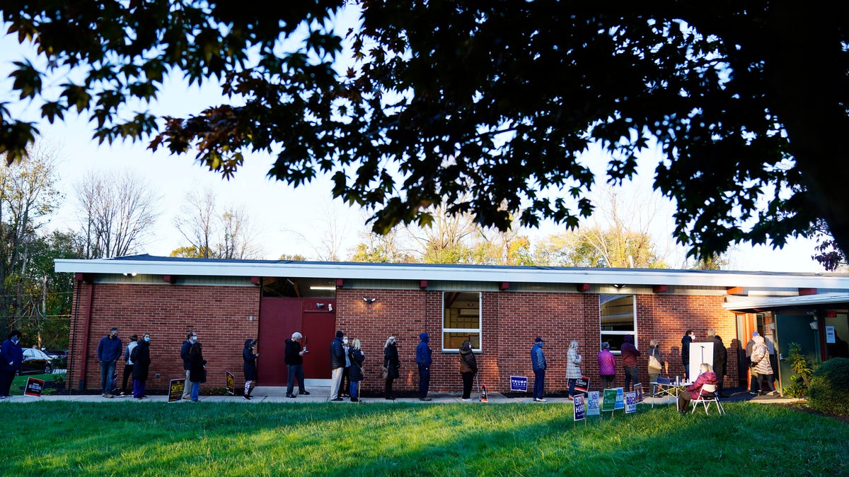People line up outside a polling place to vote in the 2020 general election Tuesday, Nov. 3, 2020, in Springfield, Pa. (AP Photo/Matt Slocum)