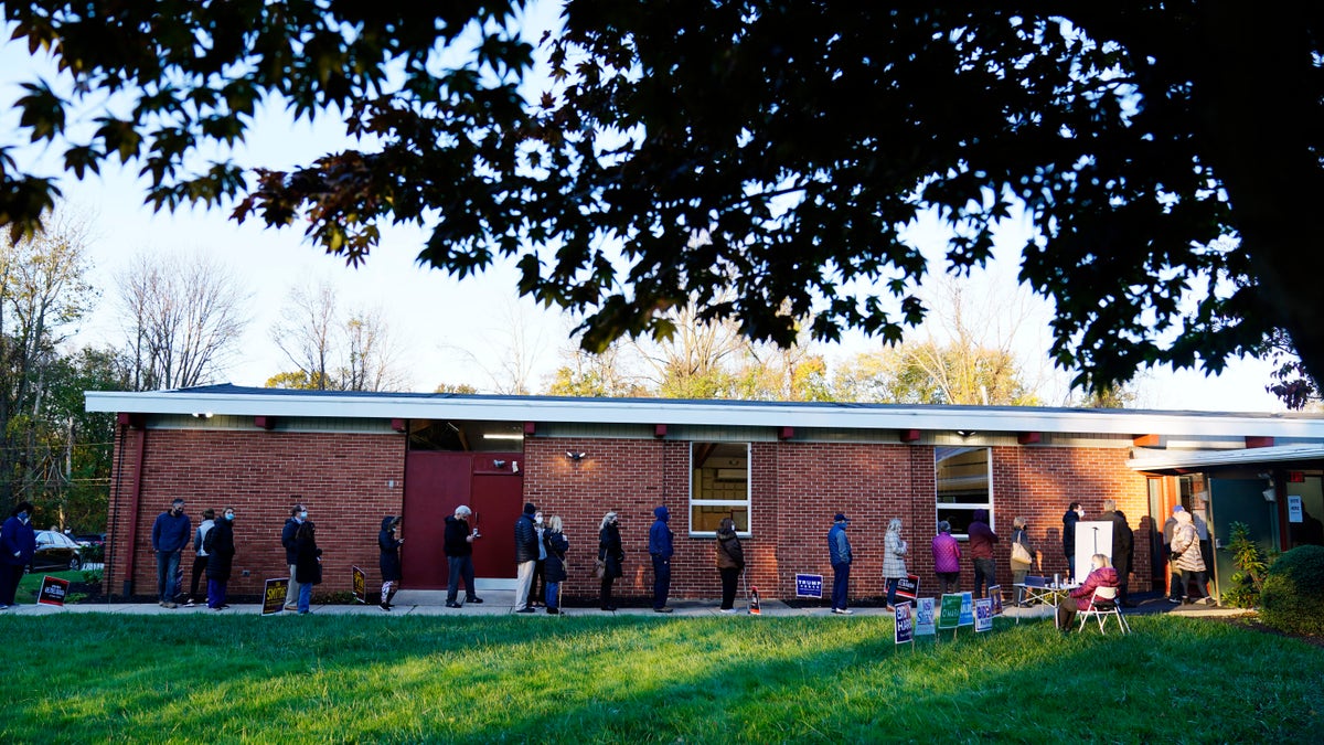People line up outside a polling place to vote in the 2020 general election Tuesday, Nov. 3, 2020, in Springfield, Pa. (AP Photo/Matt Slocum)