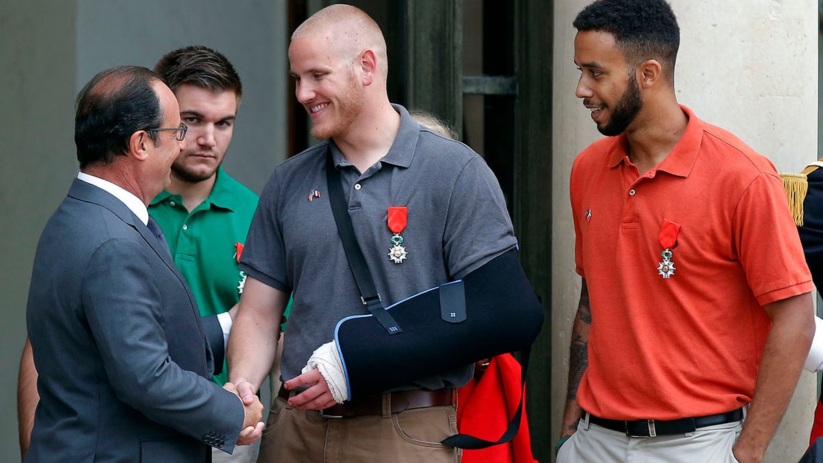 French President Francois Hollande bids farewell to U.S. Airman Spencer Stone as U.S. National Guardsman Alek Skarlatos of Roseburg, Ore., second from left, and Anthony Sadler, a senior at Sacramento State University in California, right, after Hollande awarded them the French Legion of Honor at the Elysee Palace in Paris. (AP Photo/Michel Euler, File)