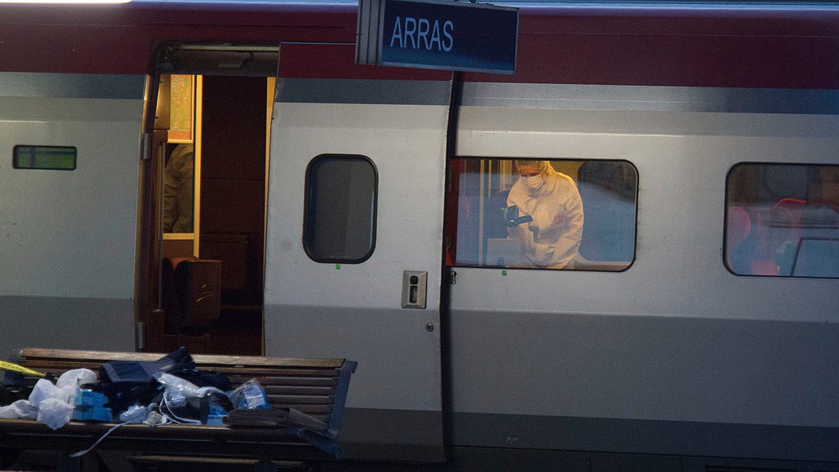 In this Aug.21, 2015 file photo, a police officer videos the crime scene inside a Thalys train at Arras train station, northern France, after a gunman opened fire with an automatic weapon. (AP Photo, File)