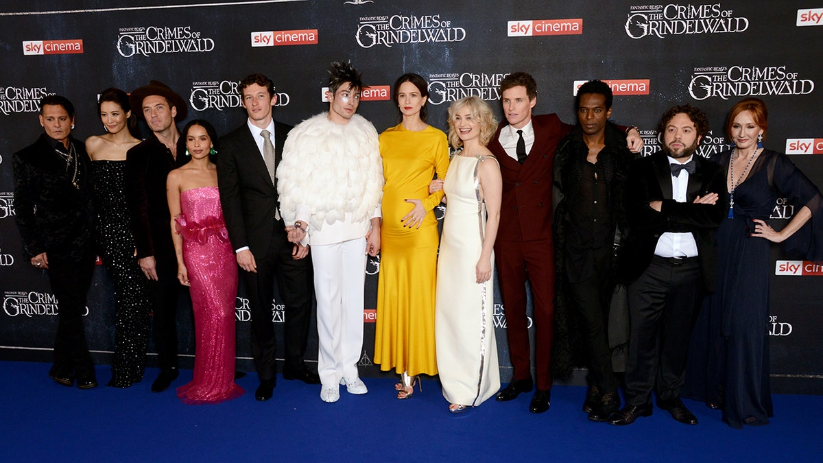 ""Fantastic Beasts: The Crimes Of Grindelwald' cast, from left: Johnny Depp, Claudia Kim, Jude Law, Zoe Kravitz, Callum Turner, Ezra Miller, Katherine Waterston, Alison Sudol, Eddie Redmayne, William Nadylam, Dan Fogler and screenwriter J.K. Rowling. (Getty Images)