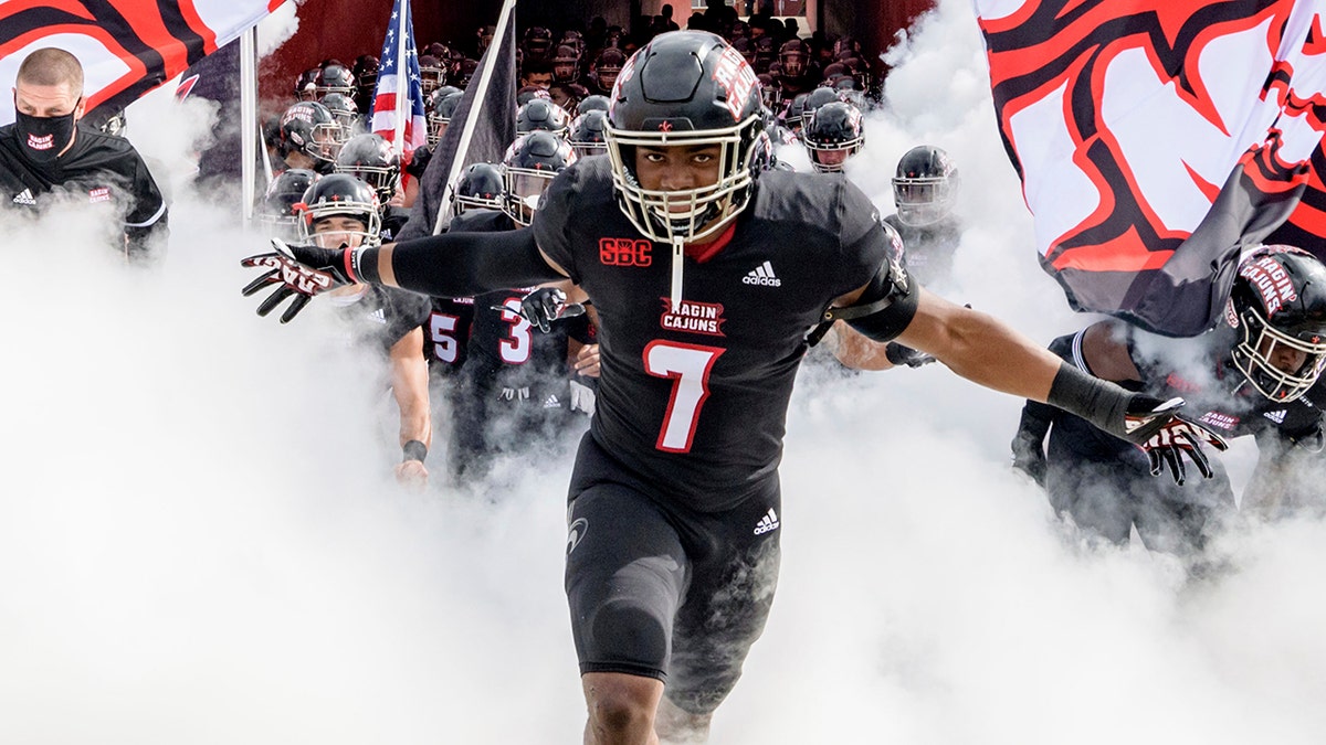 Louisiana-Lafayette linebacker Ferrod Gardner (7) enters the field with Louisiana-Lafayette head coach Billy Napier before an NCAA college football game against South Alabama in Lafayette, La., Saturday, Nov. 14, 2020. (AP Photo/Matthew Hinton)