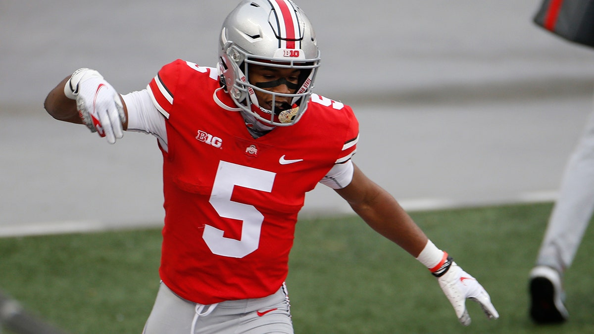 Ohio State receiver Garrett Wilson celebrates his touchdown against Indiana during the first half of an NCAA college football game Nov. 21, in Columbus, Ohio. (AP Photo/Jay LaPrete)