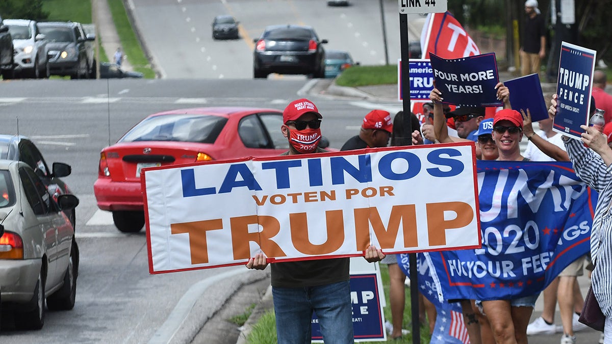 October 10, 2020 - Orlando, Florida, United States - People hold placards after U.S. Vice President Mike Pence addressed supporters at a Latinos for Trump campaign rally at Central Christian University on October 10, 2020 in Orlando, Florida. With 24 days until the 2020 presidential election, both Donald Trump and Democrat Joe Biden are courting the Latino vote as Latinos are the largest racial or ethnic minority in the electorate, with 32 million eligible voters. (Photo by Paul Hennessy/NurPhoto via Getty Images)