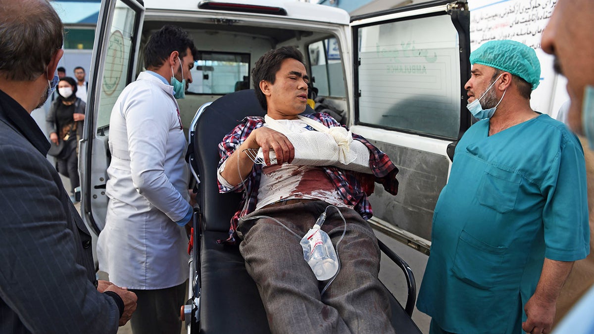 A man, wounded after gunmen stormed Kabul university, arrives in an ambulance to Isteqlal Hospital in Kabul on November 2, 2020. - Gunmen stormed Kabul university on November 2 ahead of the opening of an Iranian book fair, firing shots and sending students fleeing, Afghan officials and witnesses said. (Photo by WAKIL KOHSAR / AFP) (Photo by WAKIL KOHSAR/AFP via Getty Images)