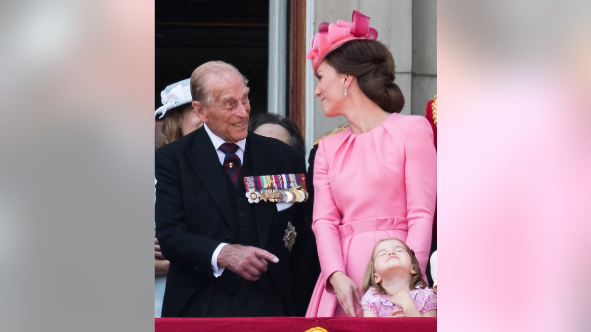 Prince Philip, Duke of Edinburgh, Catherine, Duchess of Cambridge, Princess Charlotte of Cambridge look on from the balcony during the annual Trooping The Colour parade on June 17, 2017, in London, England.