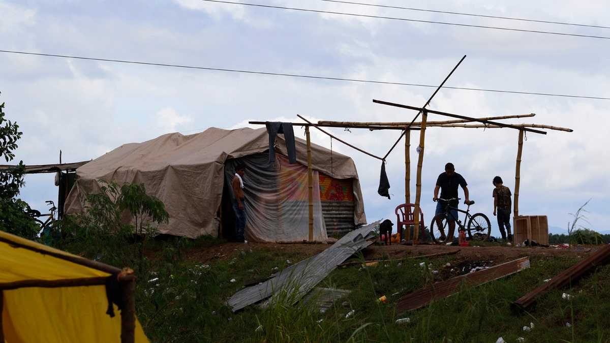 People living under precarious conditions make preparations before Hurricane Iota makes landfall in San Manuel Cortes, Honduras, Monday, November 16, 2020. Hurricane Iota rapidly strengthened into a Category 5 storm that is likely to bring catastrophic damage to the same part of Central America already battered by a powerful Hurricane Eta less than two weeks ago.