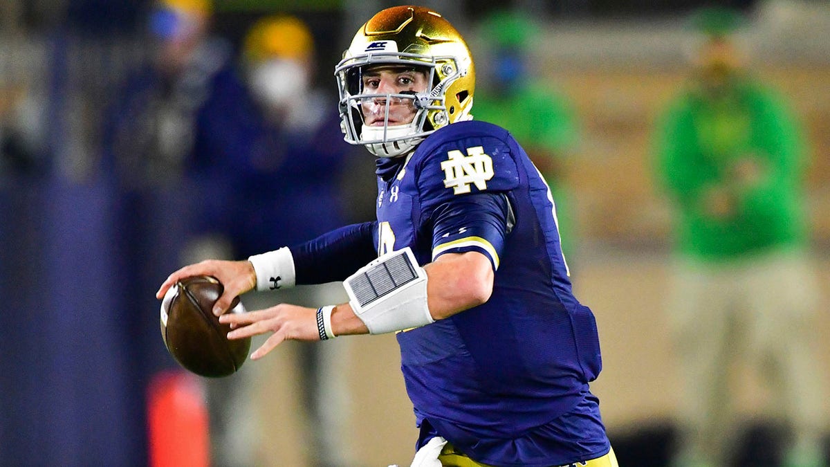 Notre Dame quarterback Ian Book looks for a receiver during the first quarter against Clemson in an NCAA college football game Saturday, Nov. 7, 2020, in South Bend, Ind. (Matt Cashore/Pool Photo via AP)