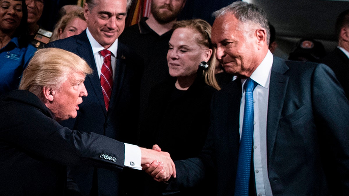 US President Donald Trump shakes Ike Perlmutter, CEO of Marvel Entertainment, hand before signing an executive order at the US Department of Veterans Affairs April 27, 2017 in Washington, DC. / AFP PHOTO / Brendan Smialowski (Photo credit should read BRENDAN SMIALOWSKI/AFP via Getty Images)