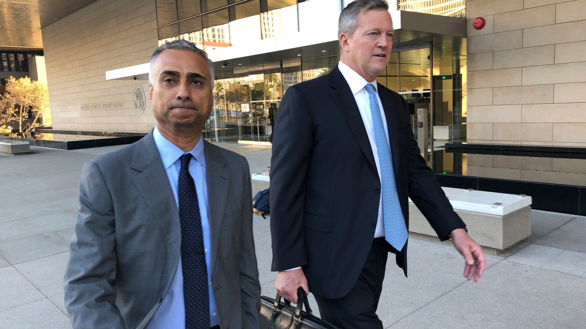 FILE - In this Nov. 22, 2019 file photo, Imaad Zuberi, left, leaves the federal courthouse in Los Angeles with his attorney Thomas O'Brien, right, after pleading guilty to funneling donations from foreigners to U.S. political campaigns. Zuberi, an elite political fundraiser, had the ear of top Democrats and Republicans alike — a reach that included private meetings with then-Vice President Joe Biden and VIP access at Donald Trump’s inauguration. But federal prosecutors say Zuberi’s life was built on a series of lies and the lucrative enterprise of filling the campaign coffers of American politicians and profiting from the resulting influence. They describe him as a “mercenary” political donor who gave to anyone -- often using foreign money given through illegal straw donors. (AP Photo/Brian Melley, File)