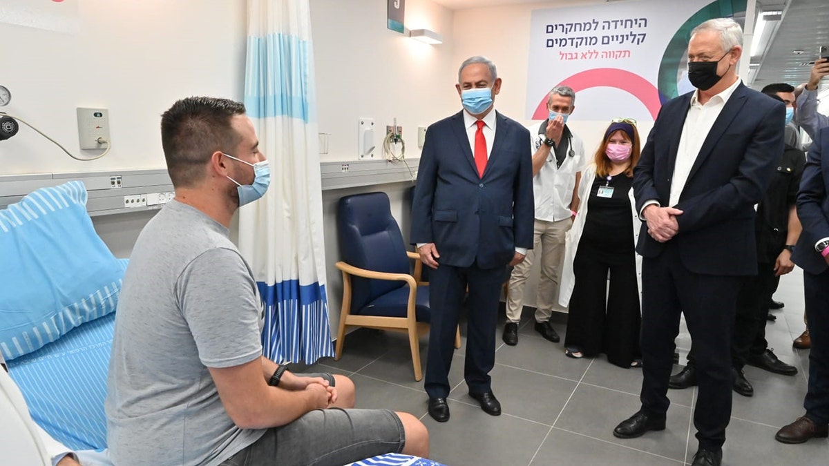 Segev Harel meets with Prime Minister Benjamin Netanyahu and Defense Minister Benny Gantz at Sheba Medical Center in Tel Aviv.