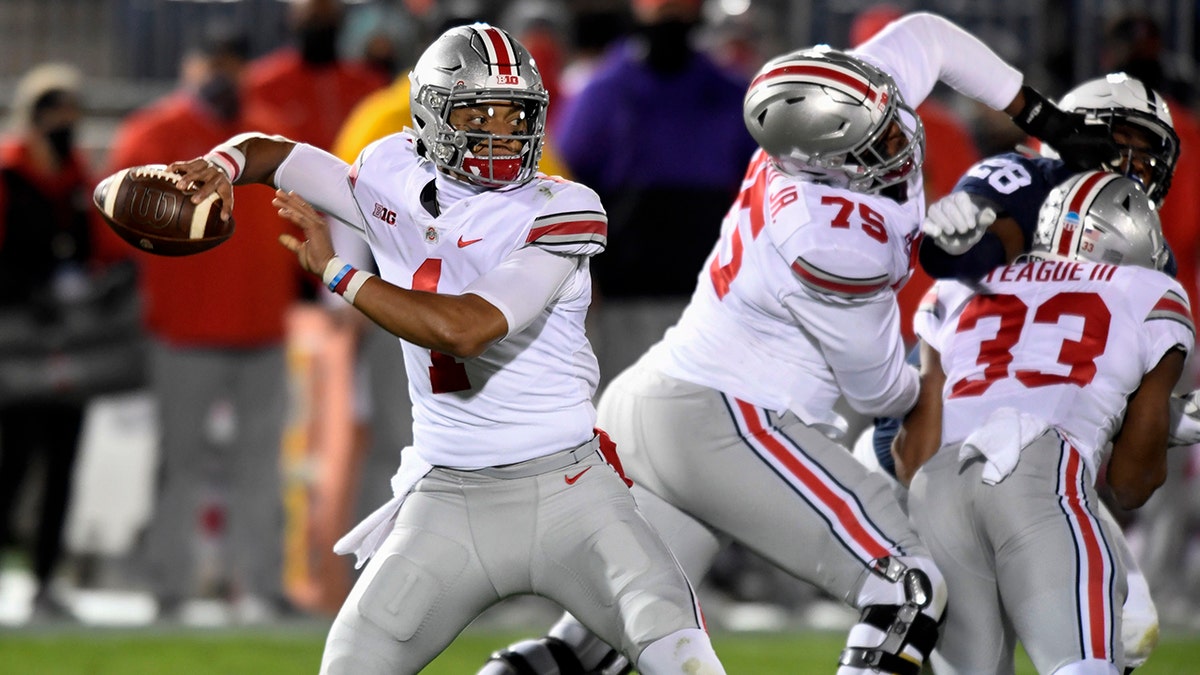 Ohio State quarterback Justin Fields (1) looks for a receiver during the first quarter against Penn State in an NCAA college football game in State College, Pa., Saturday, Oct. 31, 2020. (AP Photo/Barry Reeger)