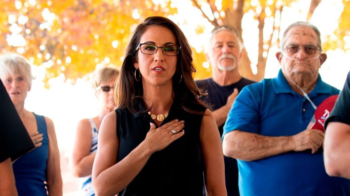 Lauren Boebert (C), the Republican candidate for the US House of Representatives seat in Colorado's 3rd Congressional District, recites the Pledge of Allegiance before addressing supporters at a campaign rally in Delta, Colorado on October 10, 2020. (Photo by JASON CONNOLLY/AFP via Getty Images)