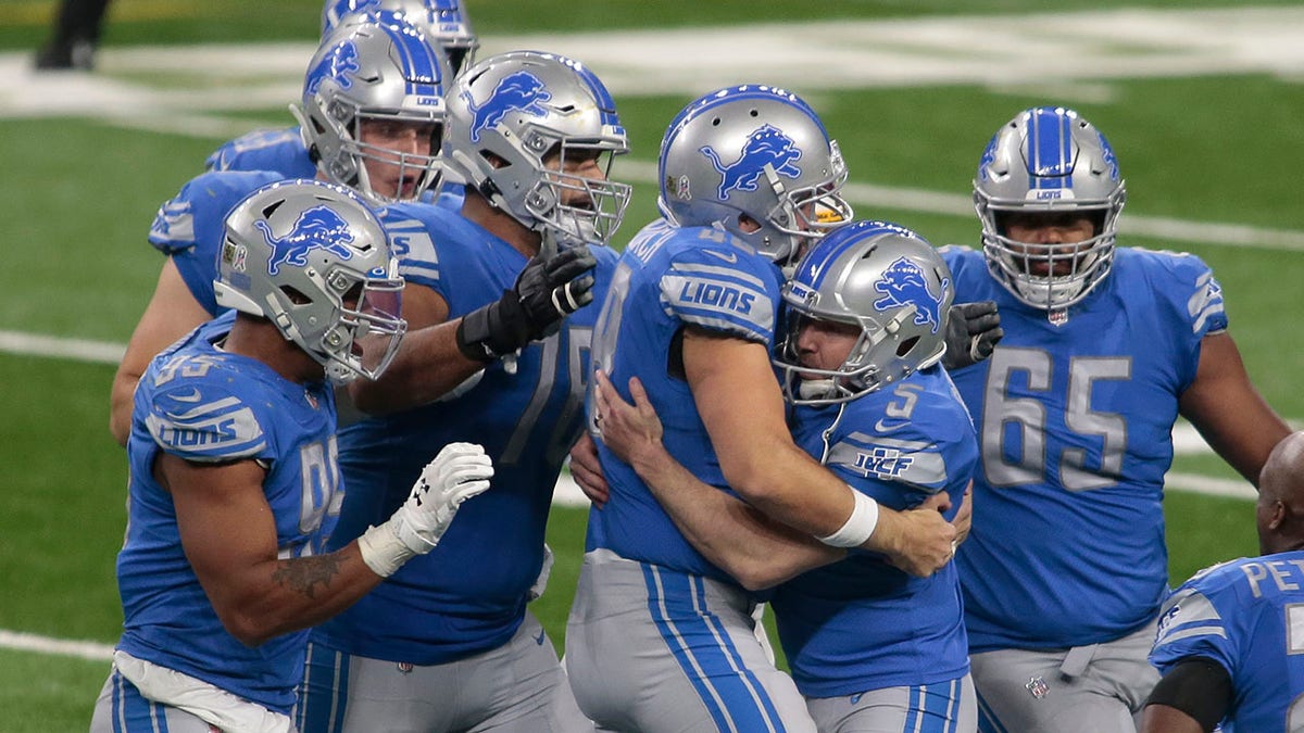 Detroit Lions teammates surround kicker Matt Prater (5) after his winning field goal in the closing seconds during the second half of an NFL football game against the Washington Football Team, Sunday, Nov. 15, 2020, in Detroit. (AP Photo/Tony Ding)