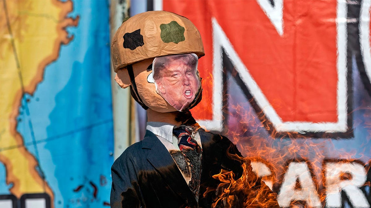 A Trump piñata is burnt during a protest against his administration's immigration policies on the U.S. border in Tijuana.