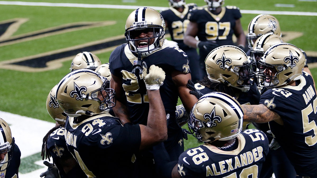 New Orleans Saints players hoist cornerback Patrick Robinson (21) after his late game interception in the end zone in the second half of an NFL football game against the San Francisco 49ers in New Orleans, Sunday, Nov. 15, 2020. The Saints won 27-13. (AP Photo/Brett Duke)