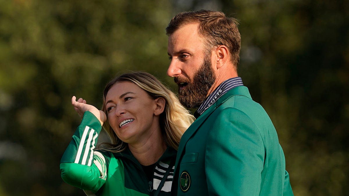 Masters golf champion Dustin Johnson is hugged by Paulina Gretzky after his victory Sunday, Nov. 15, 2020, in Augusta, Ga.