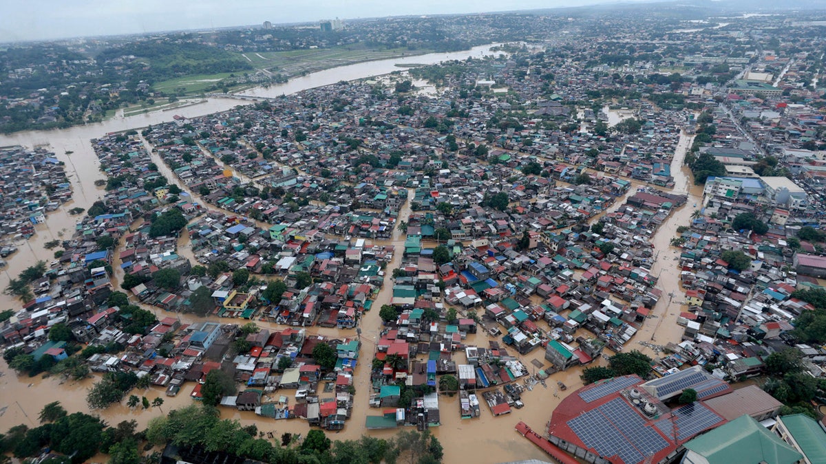 In this photo provided by the Malacanang Presidential Photographers Division, floodwaters inundate Metro Manila, Philippines, Thursday, Nov. 12, 2020.