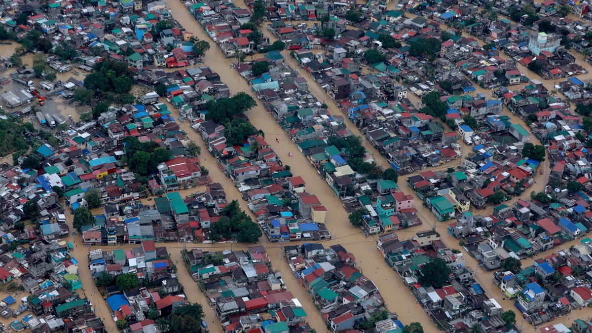 In this photo provided by the Malacanang Presidential Photographers Division, floodwaters bought by Typhoon Vamco inundate Metro Manila, Philippines, Thursday, Nov. 12, 2020.