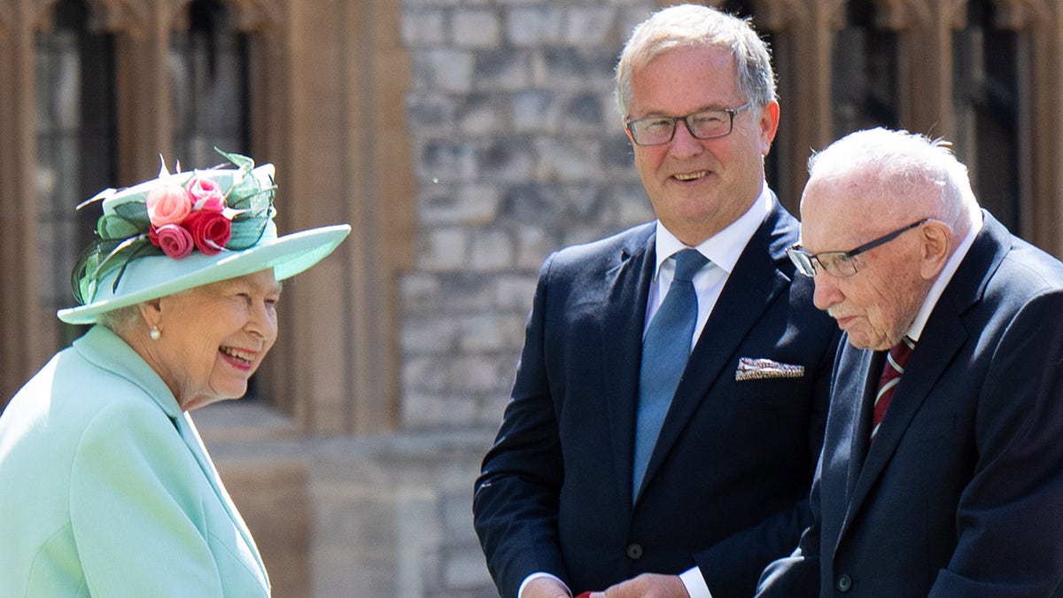 Queen Elizabeth II talks with Captain Sir Thomas Moore and his family at Windsor Castle on July 17, 2020. She has not been photographed publicly with a face mask. (Photo by Pool/Samir Hussein/WireImage)