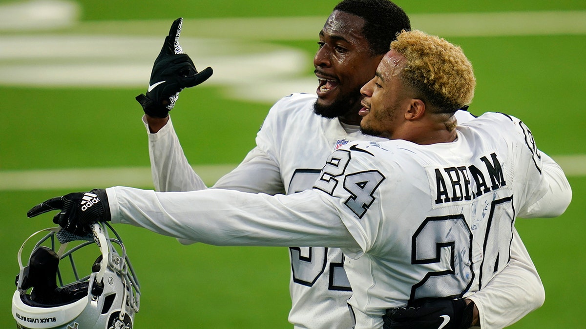 Las Vegas Raiders cornerback Isaiah Johnson, left, and strong safety Johnathan Abram (24) celebrate after the Raiders defeated the Los Angeles Chargers in an NFL football game Sunday, Nov. 8, 2020, in Inglewood, Calif. (AP Photo/Alex Gallardo)