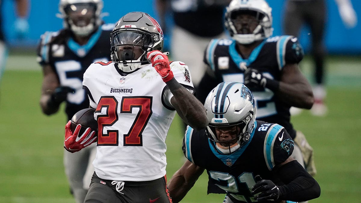 Tampa Bay Buccaneers running back Ronald Jones (27) runs for a 98-yard touchdown against the Carolina Panthers during the second half of an NFL football game, Sunday, Nov. 15, 2020, in Charlotte , N.C. (AP Photo/Gerry Broome)