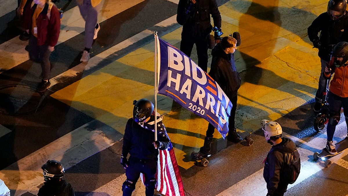 People gather in Black Lives Matter Plaza near the White House in Washington, Tuesday, Nov. 3, 2020, on Election Day. (AP Photo/Susan Walsh)
