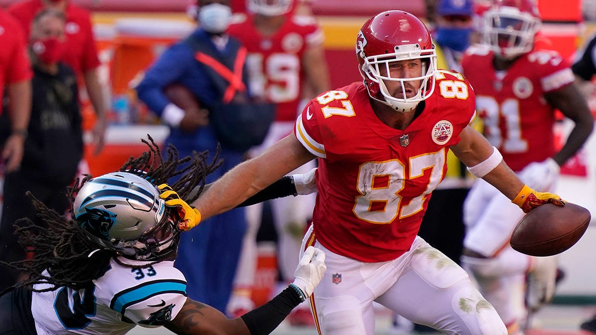 Kansas City Chiefs tight end Travis Kelce (87) runs against Carolina Panthers free safety Tre Boston (33) during the second half of an NFL football game in Kansas City, Mo., Sunday, Nov. 8, 2020. (AP Photo/Jeff Roberson)