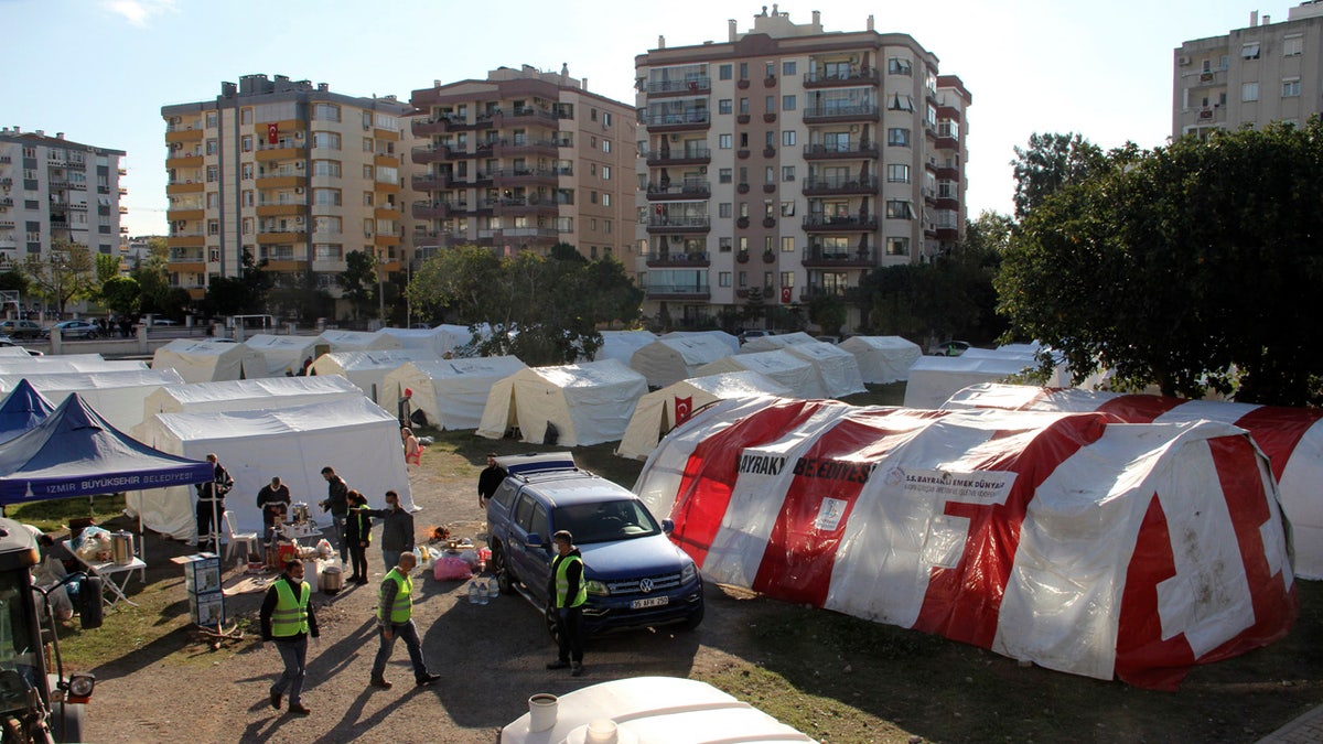 Local residents stay outdoors for fear of strong aftershocks after an earthquake collapsed their houses, in Izmir, Turkey, Sunday, Nov. 1, 2020. The strong earthquake in the Aegean Sea struck Turkey and Greece on Friday.