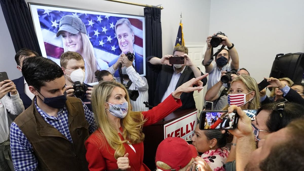 In this Nov. 11, 2020 photo, Republican candidate for U.S. Senate Sen. Kelly Loeffler gestures to supporters after speaking at a campaign rally in Marietta, Ga. Republicans are flooding Georgia with cash and field operatives as they look to keep Democrats from seizing control of the Senate under President-elect Joe Biden’s administration. The Republican National Committee says it is funding more than 600 staffers in the state with an investment of at least $20 million ahead of the Jan. 5 runoffs for the seats held by GOP Sens. Kelly Loeffler and David Perdue. (AP Photo/John Bazemore)